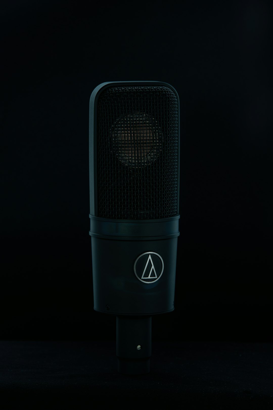 Professional podcast microphone with pop filter standing in a media studio