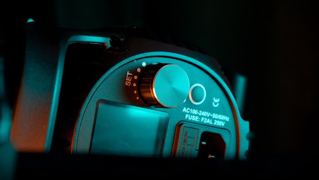 Close up of a professional broadcast camera lens with studio lights blurred in the background